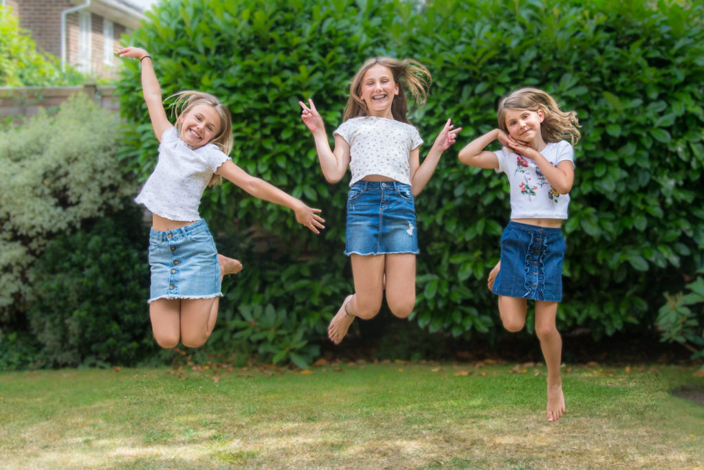 Photo of 3 children jumping at lifestyle outdoor session in Croydon, Surrey