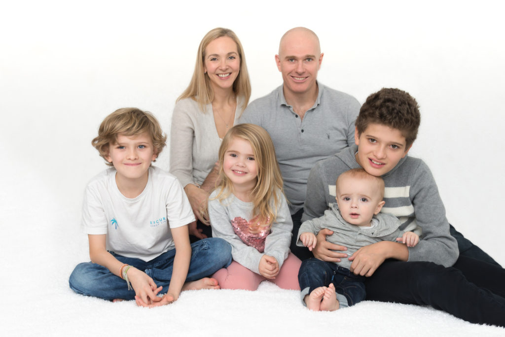Family photo of parents with their three children and newborn baby in Fulham, South West London