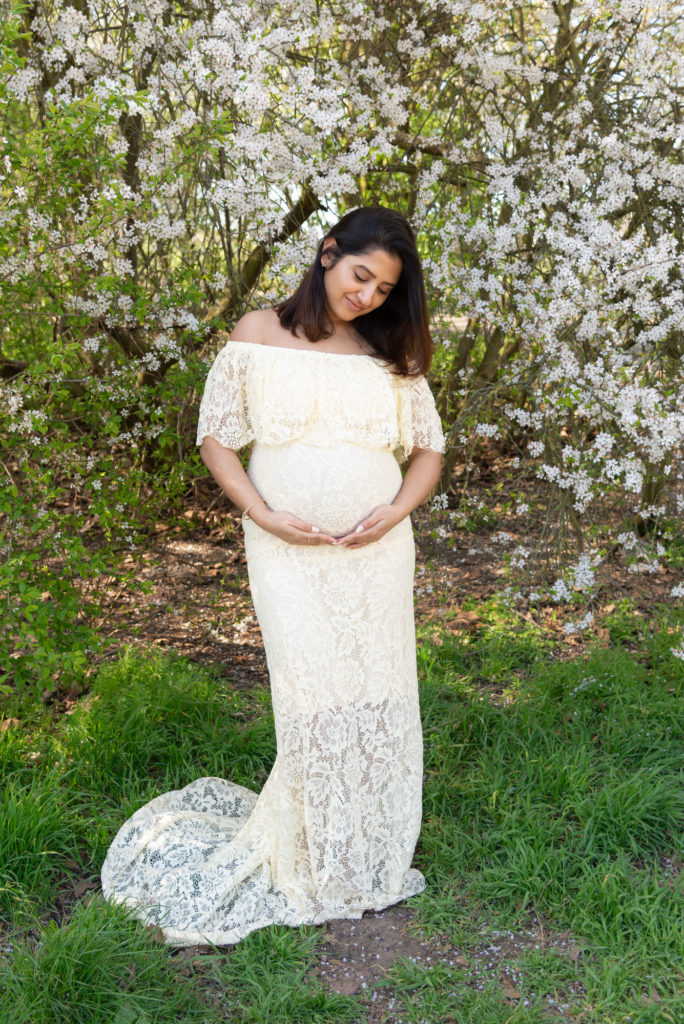 South London maternity pregnancy photographer takes photo of beautiful mum to be under white blossom