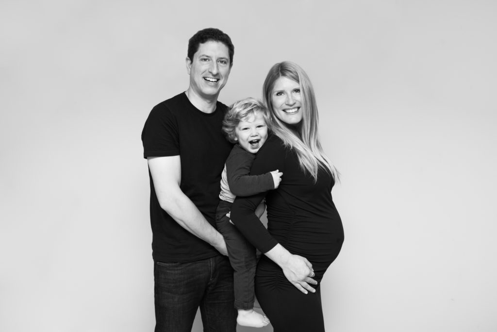 South London maternity photographer takes black and white image of pregnant family in Westminster