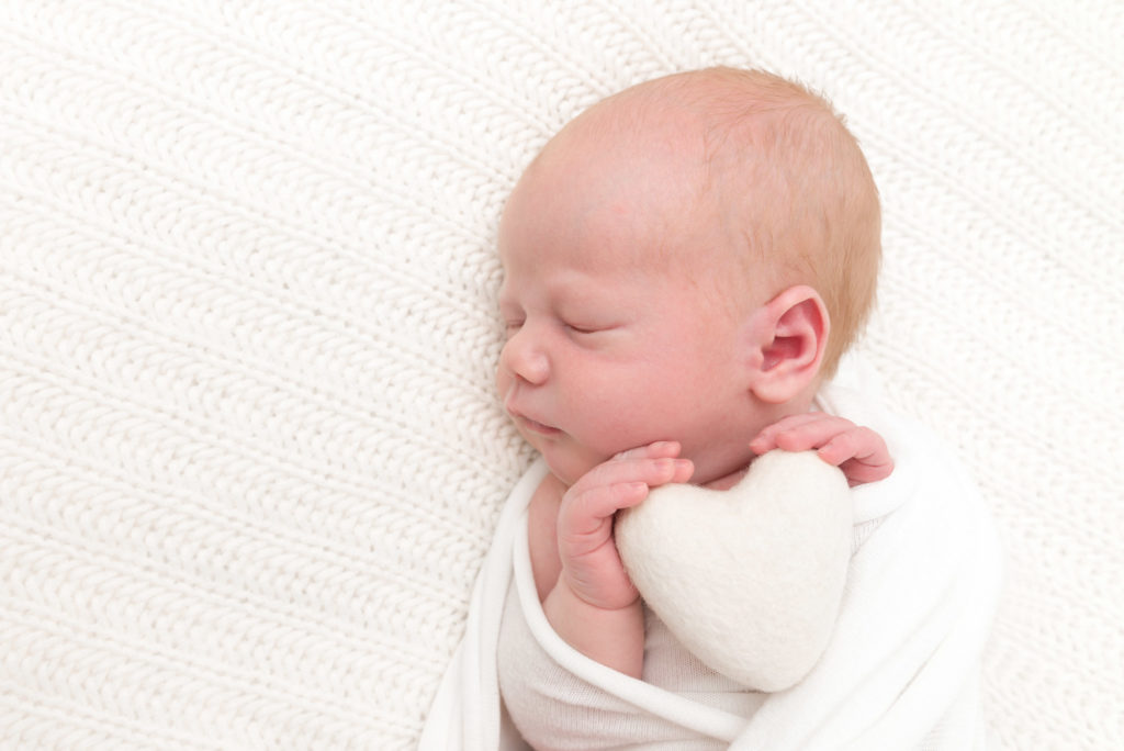 Photo of newborn baby with heart